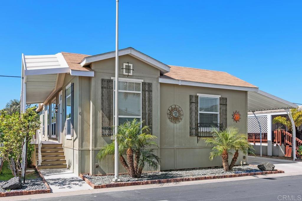 7213 San Luis Street, Unit 171 Carlsbad, CA 92011 - Photo 1 of 44 a front view of a house with a yard