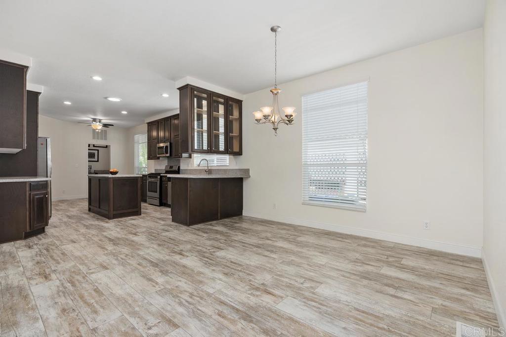 7213 San Luis Street, Unit 171 Carlsbad, CA 92011 - Photo 12 of 44 a open kitchen with kitchen island a sink stainless steel appliances and cabinets