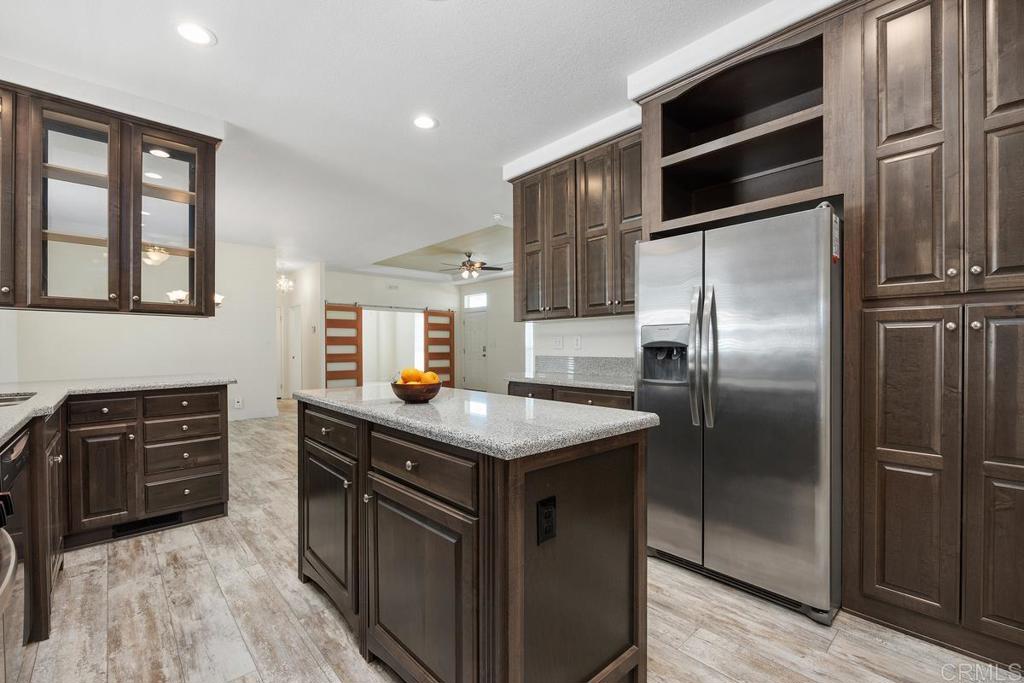 7213 San Luis Street, Unit 171 Carlsbad, CA 92011 - Photo 13 of 44 a kitchen with stainless steel appliances granite countertop a stove a refrigerator and a stove