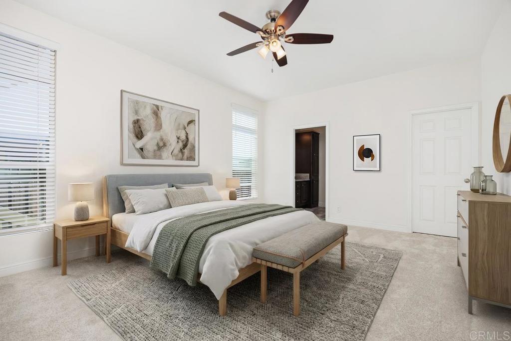 7213 San Luis Street, Unit 171 Carlsbad, CA 92011 - Photo 15 of 44 a spacious bedroom with a bed and a table
