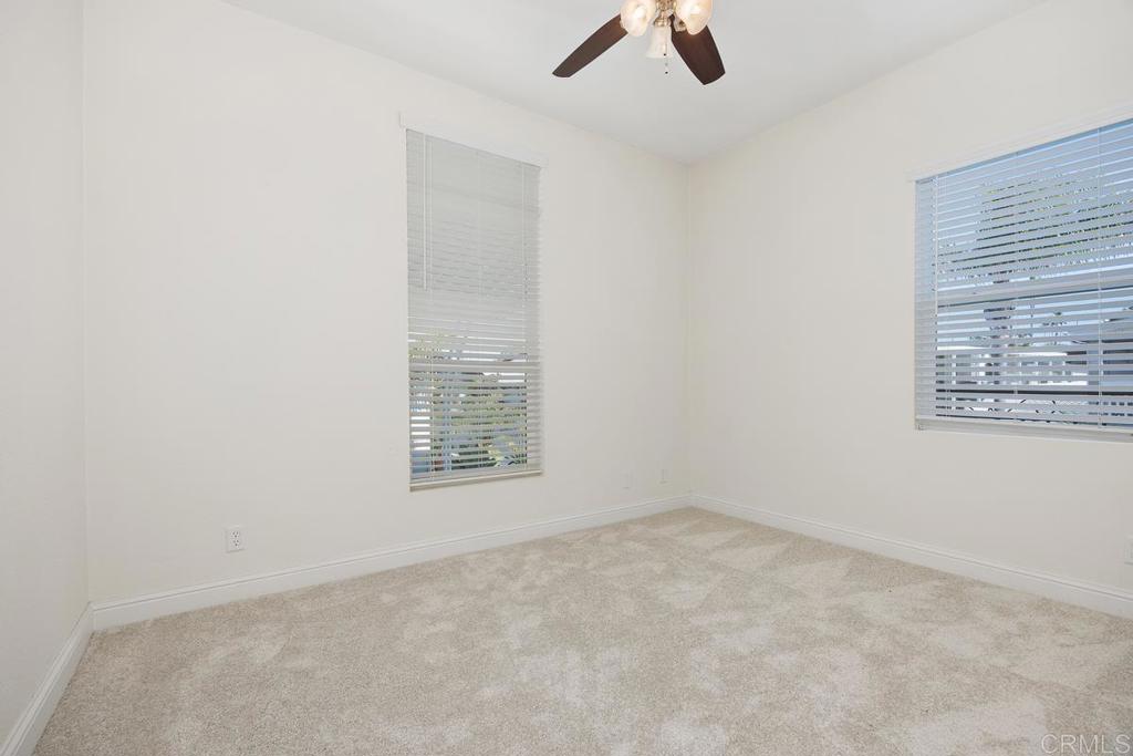 7213 San Luis Street, Unit 171 Carlsbad, CA 92011 - Photo 22 of 44 an empty room with windows