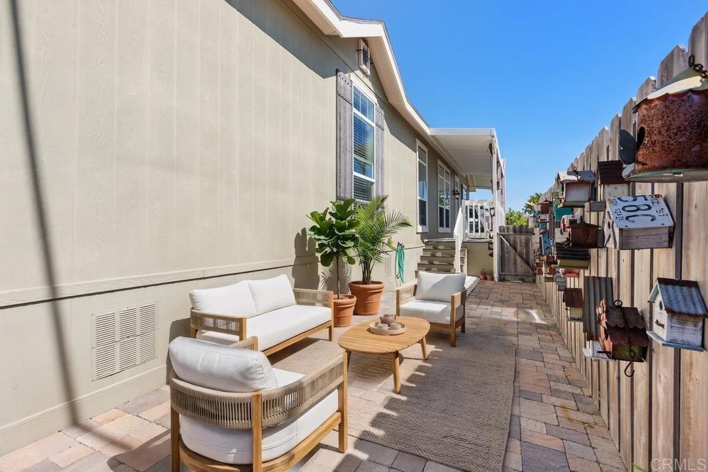 7213 San Luis Street, Unit 171 Carlsbad, CA 92011 - Photo 26 of 44 a outdoor space with patio the couches and a potted plant on the wall