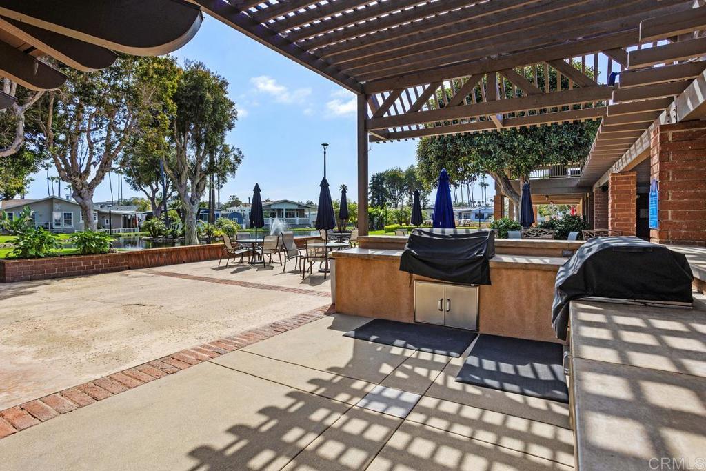 7213 San Luis Street, Unit 171 Carlsbad, CA 92011 - Photo 38 of 44 a building outdoor space with patio furniture and a potted plant