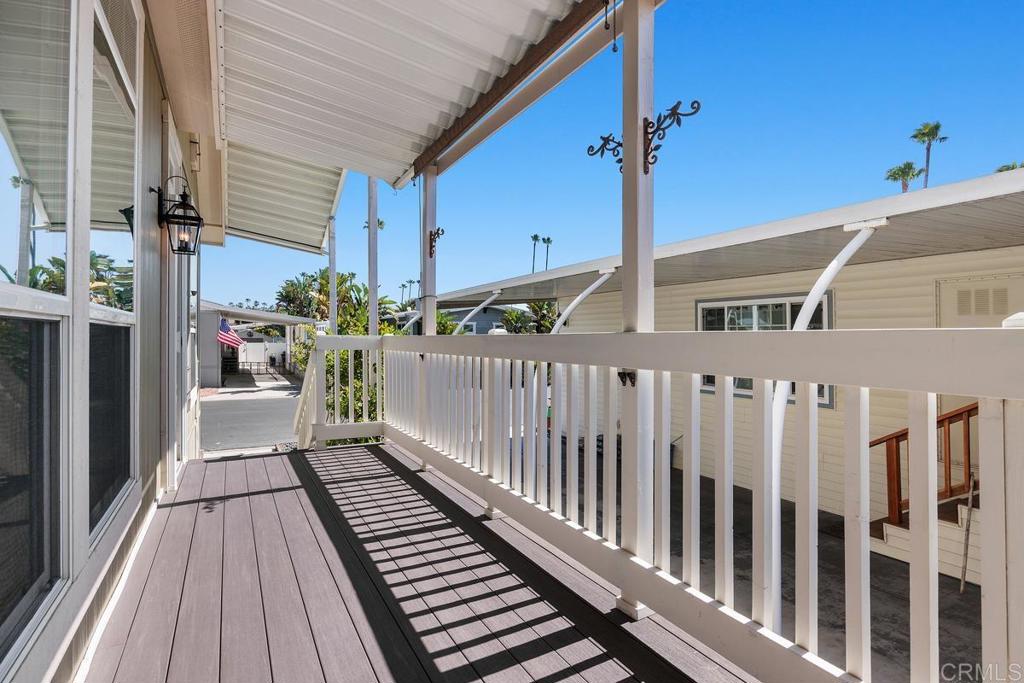 7213 San Luis Street, Unit 171 Carlsbad, CA 92011 - Photo 4 of 44 a porch with wooden floor