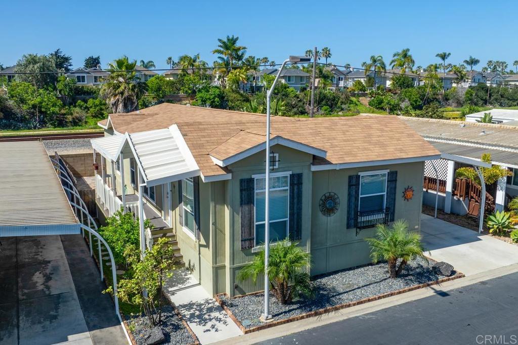 7213 San Luis Street, Unit 171 Carlsbad, CA 92011 - Photo 43 of 44 a view of a house with porch and garden