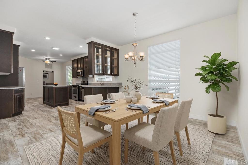 7213 San Luis Street, Unit 171 Carlsbad, CA 92011 - Photo 10 of 44 a view of a dining room with furniture window and wooden floor