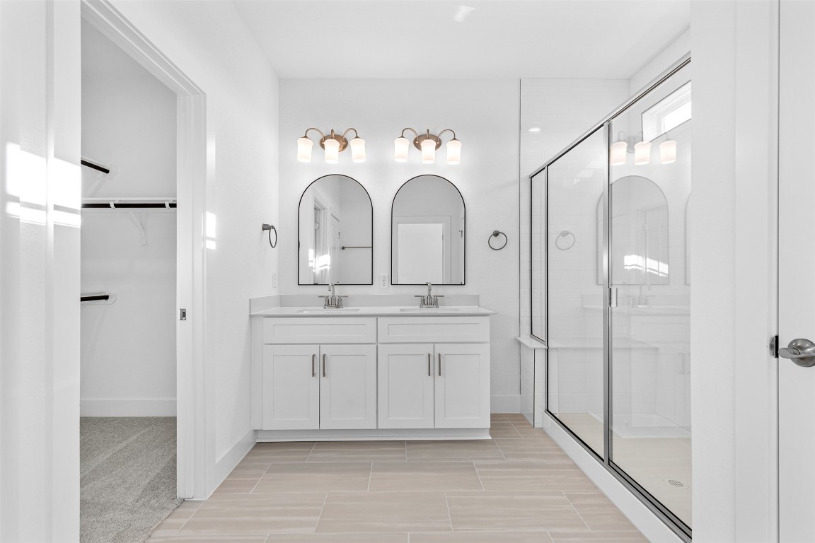 1955 Settlers Glen Drive, Unit 4301 Round Rock, TX 78665 - Photo 15 of 19 a bathroom with a double vanity sink mirror and shower