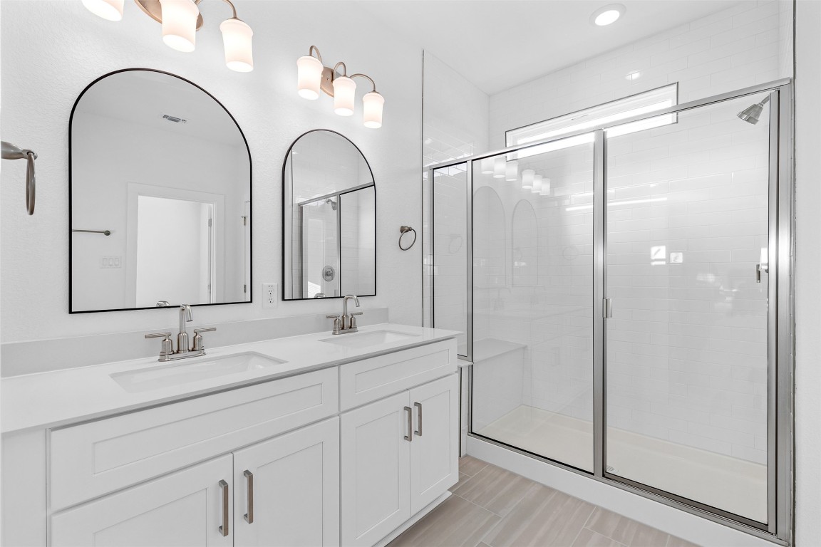 1955 Settlers Glen Drive, Unit 4301 Round Rock, TX 78665 - Photo 17 of 19 a spacious bathroom with a double vanity sink mirror and shower