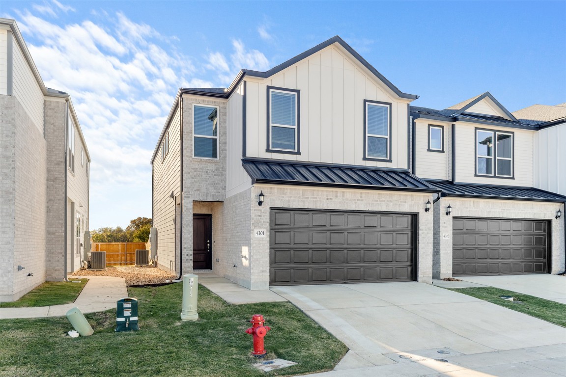 1955 Settlers Glen Drive, Unit 4301 Round Rock, TX 78665 - Photo 2 of 19 a front view of a house with garden