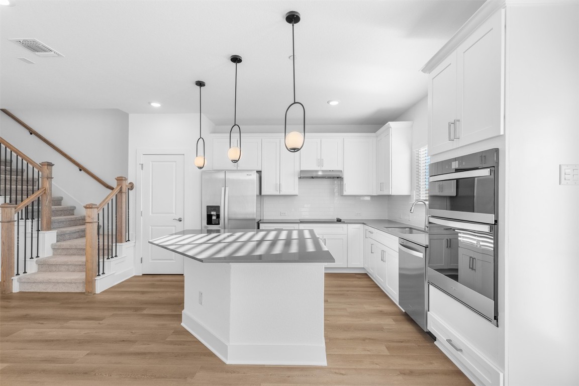 1955 Settlers Glen Drive, Unit 4301 Round Rock, TX 78665 - Photo 5 of 19 a kitchen with stainless steel appliances granite countertop a stove a sink and a refrigerator
