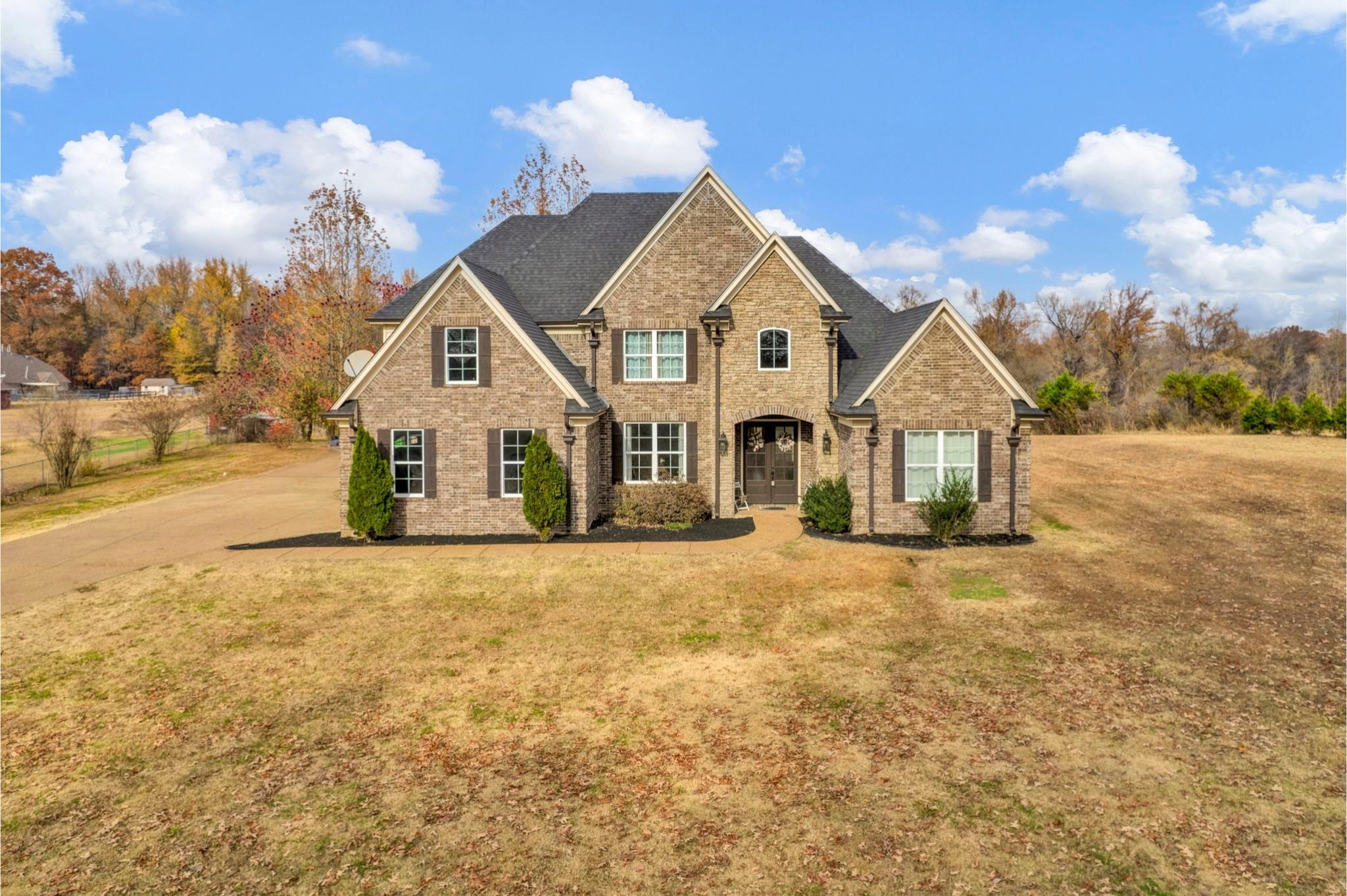 3270 Rast Road Millington, TN 38053 - Photo 1 of 40 Traditional-style house with a front lawn, brick siding, a shingled roof, and driveway
