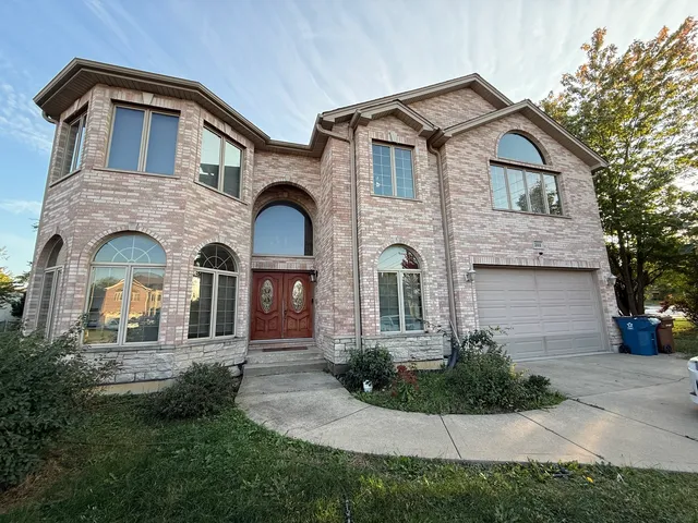a front view of a house with yard and garage