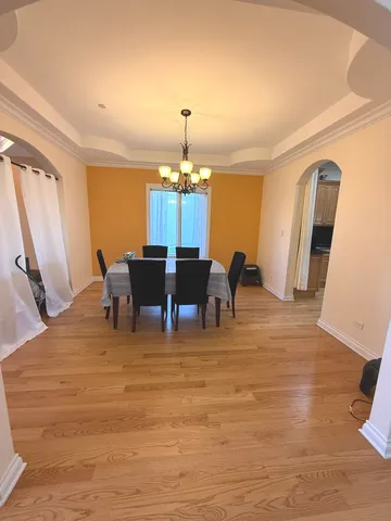 a view of a dining room with furniture and chandelier