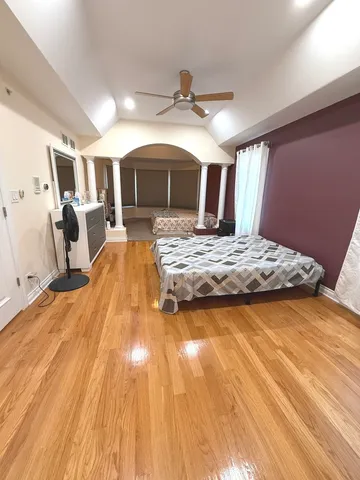 a bedroom with a large bed and a tv