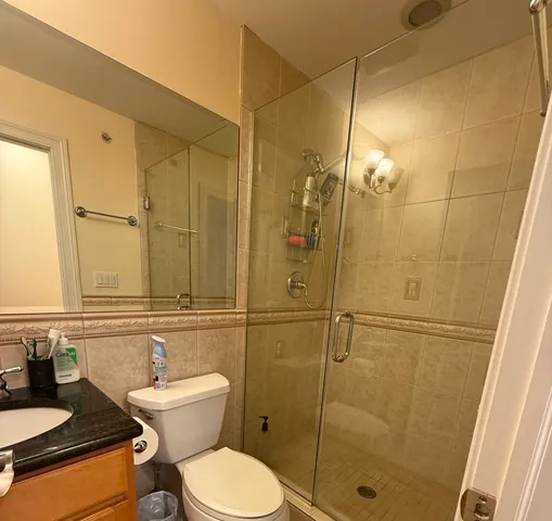 a bathroom with a toilet sink and shower