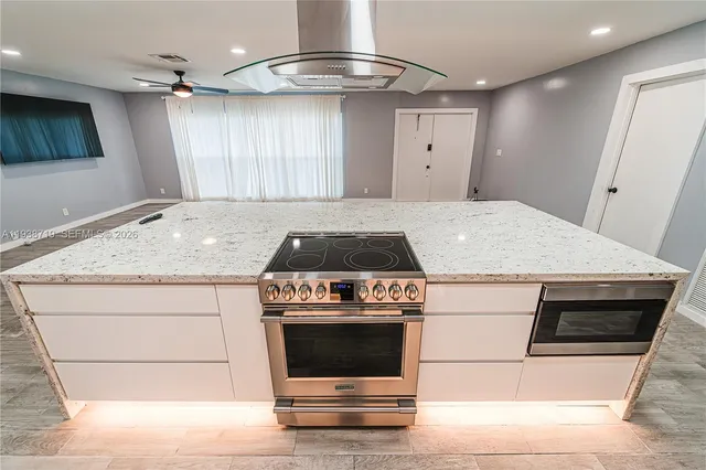 a view of work space with wooden floor and a ceiling fan