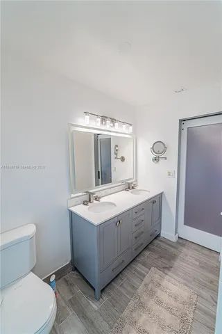 a bathroom with a sink toilet and window