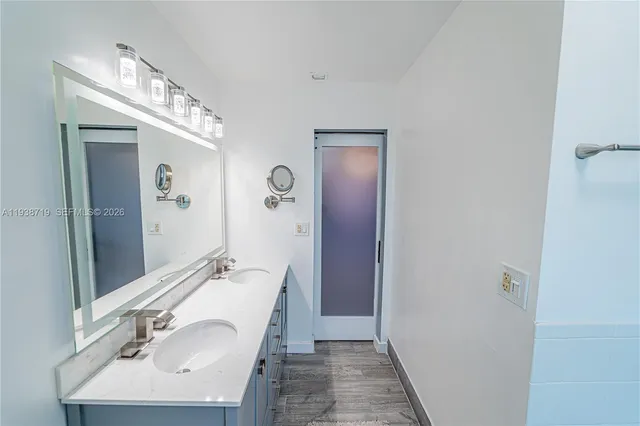 a front view of a house with a garden and trees