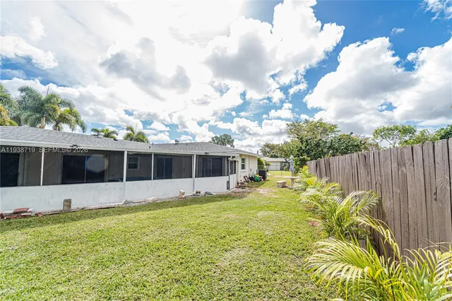 a white house with a tree in front of it
