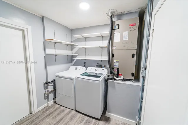 a view of a kitchen with refrigerator stove and wooden floor