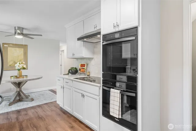 a kitchen with stainless steel appliances cabinets and a counter top space