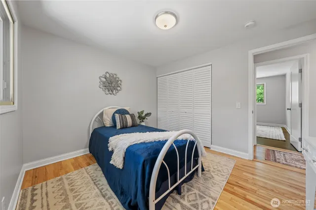 a bed room with a bed and a mirror