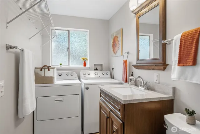 a bathroom with a sink toilet and mirror