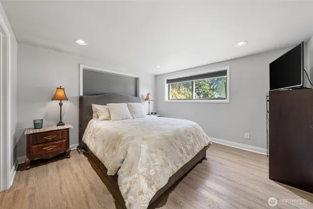 a bedroom with a bed and a television