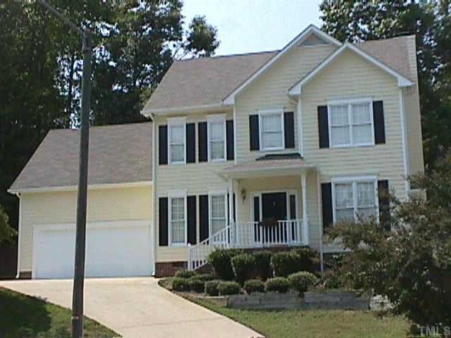 6905 Cresskill Place Raleigh, NC 27615 - Photo 1 of 1 a front view of a house with a yard and potted plants