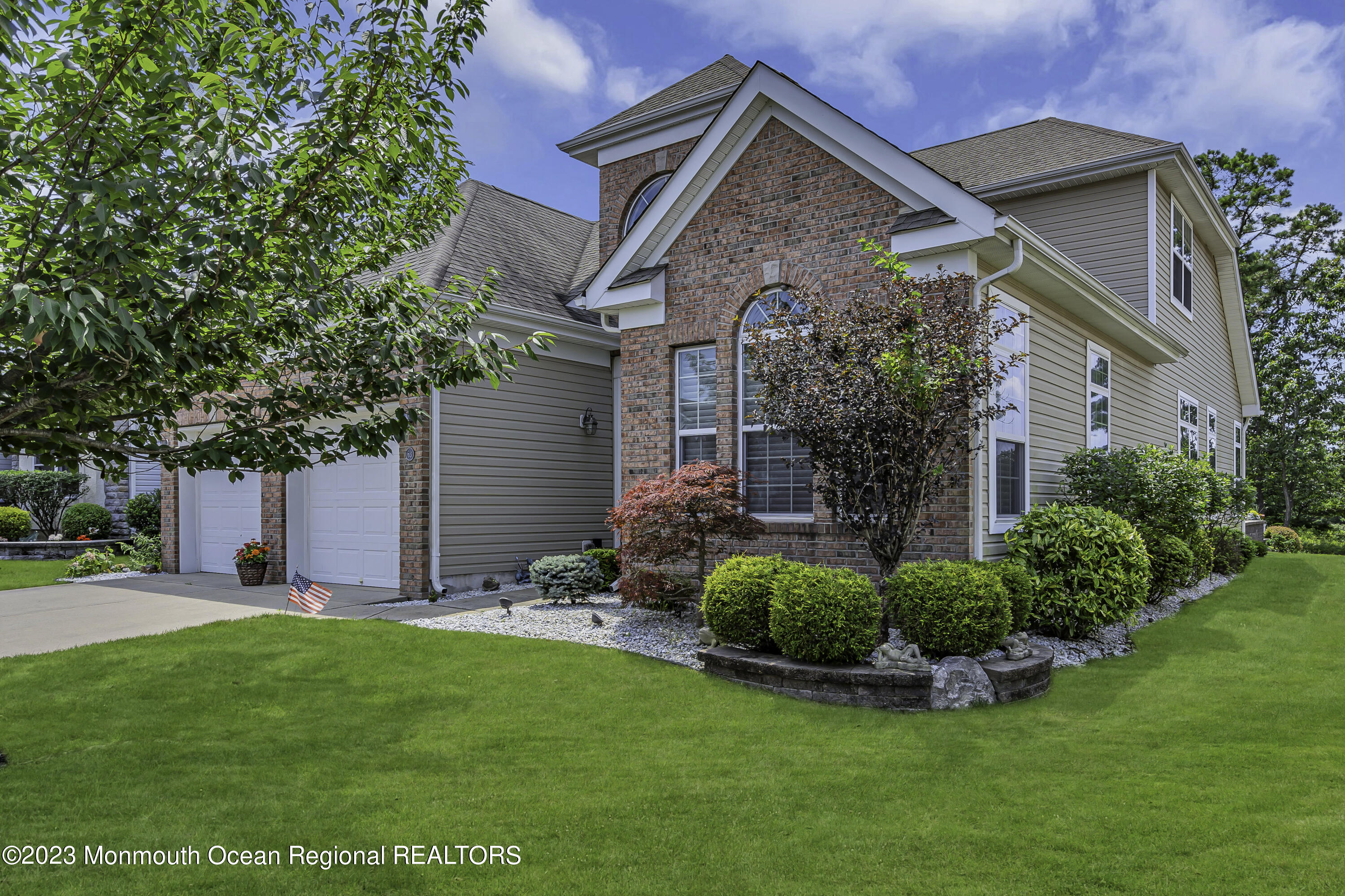 a front view of house with a garden