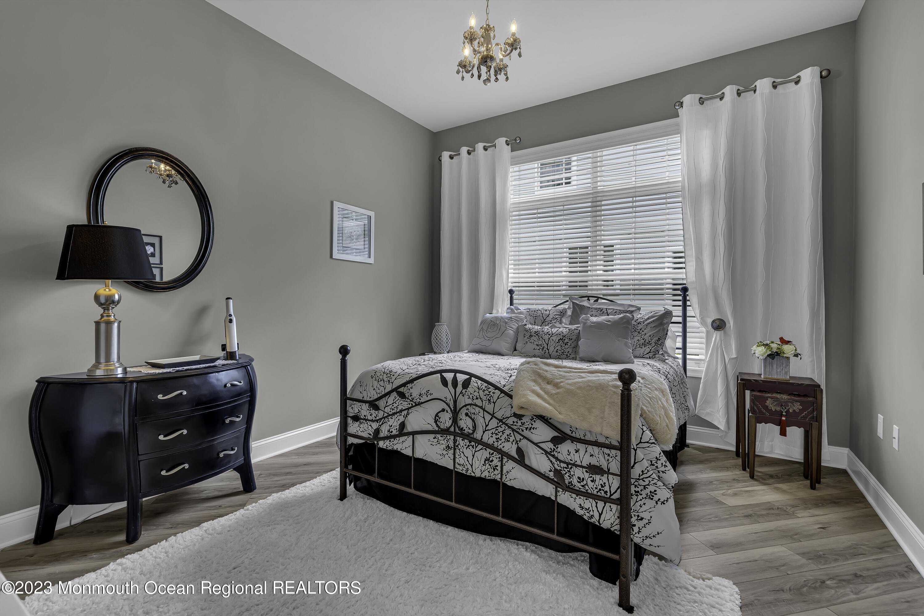 63 Harvey Cedar Way Waretown, NJ 08758 - Photo 26 of 39 a bedroom with a bed and a chandelier