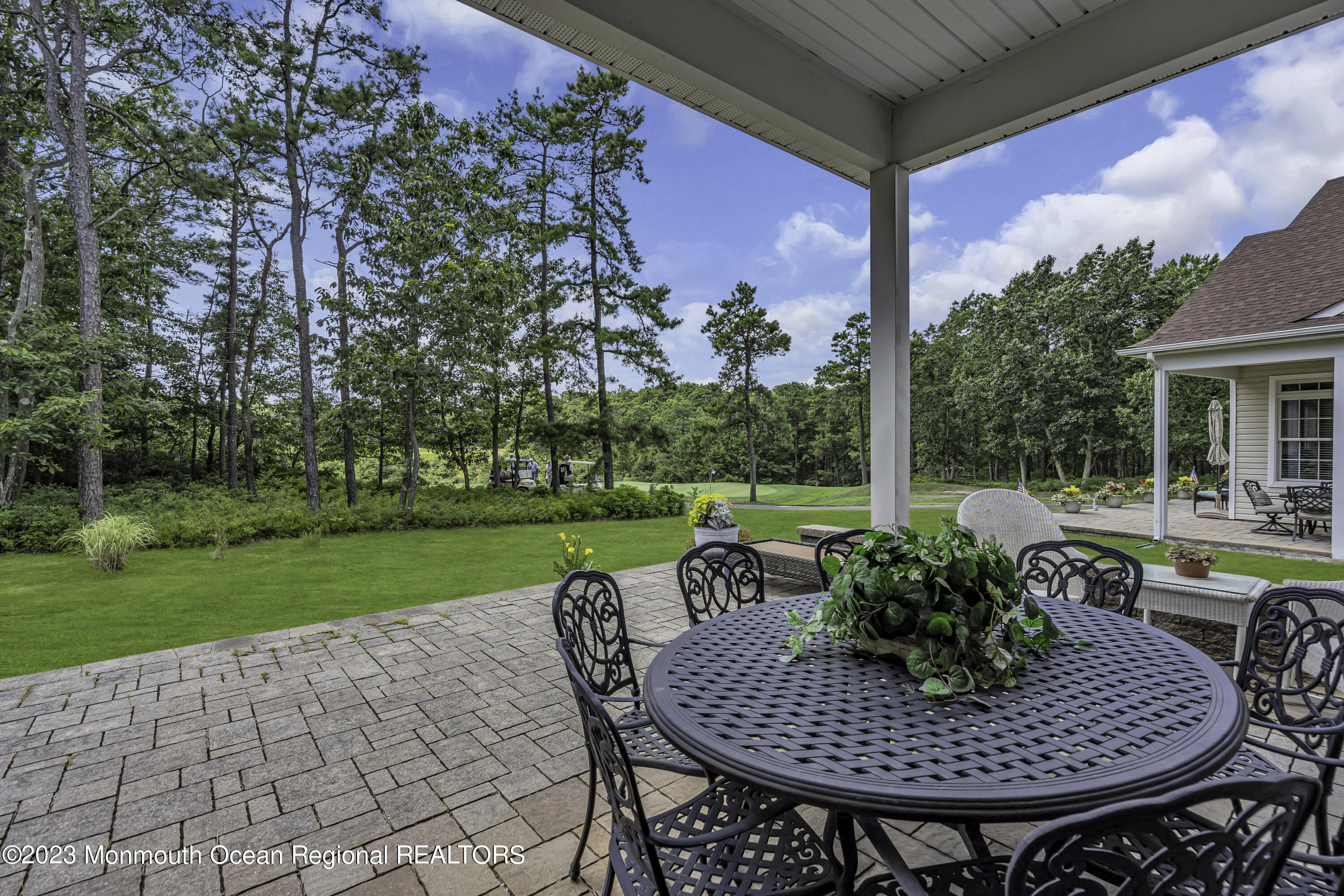 63 Harvey Cedar Way Waretown, NJ 08758 - Photo 34 of 39 a view of a patio with a table chairs and a table
