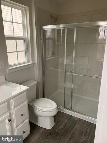 a bathroom with a toilet a sink and shower