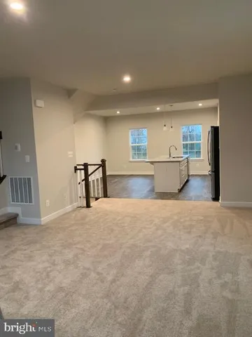 a view of a kitchen with a sink and a refrigerator