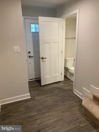 a view of a room with wooden floor and bathroom