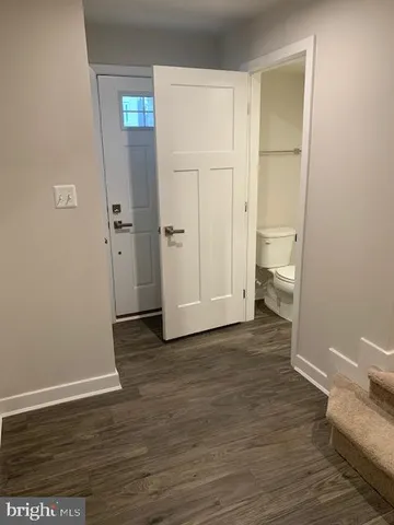 a view of a room with wooden floor and bathroom