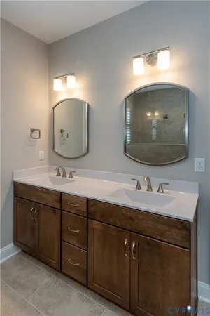 a bathroom with a double vanity sink and a mirror