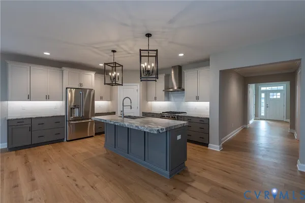 a kitchen with stainless steel appliances granite countertop a stove and a sink