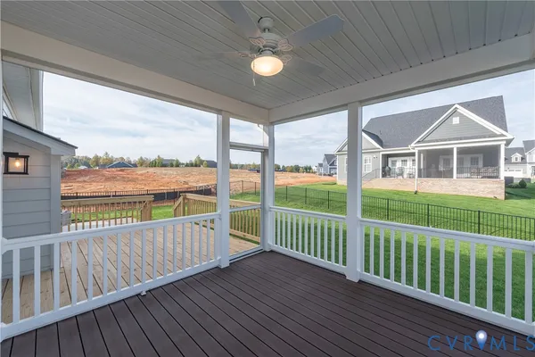 a view of a house with wooden deck and a ocean view