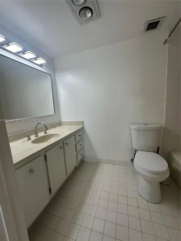 a lobby with a chair and tables