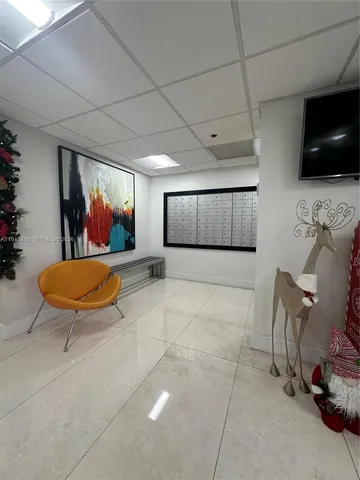 a kitchen with white cabinets and appliances