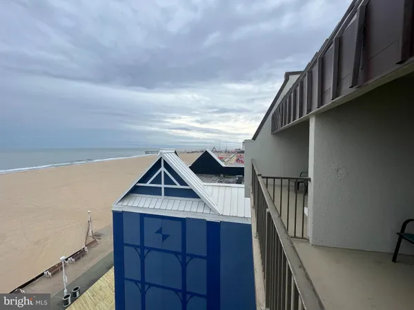 a view of roof deck with two chair and a fireplace