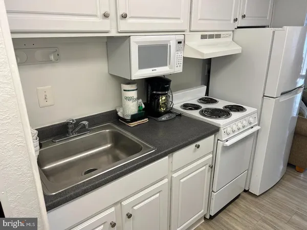 a view of a kitchen from a hallway