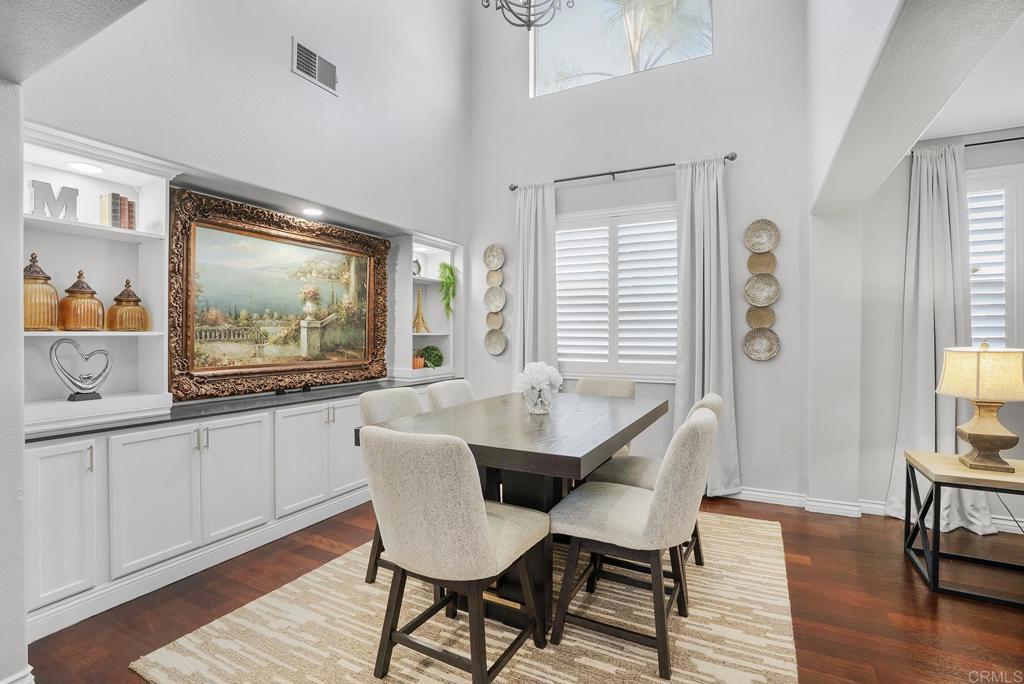 1777 Clover Tree Court Chula Vista, CA 91913 - Photo 12 of 49 a dining room with wooden floor a chandelier a wooden table and chairs