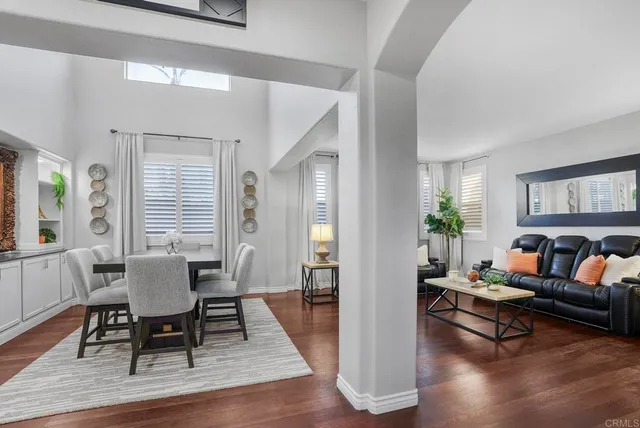 a living room with furniture rug and wooden floor