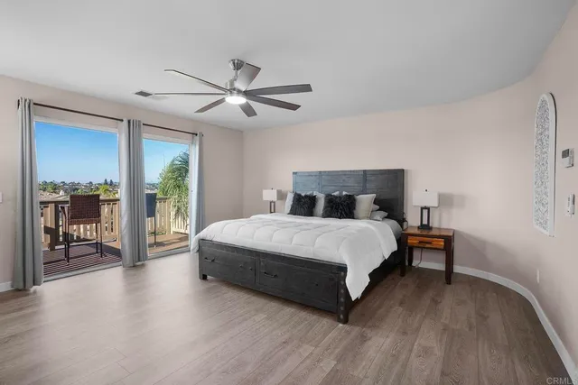 a bedroom with a large bed and a chandelier