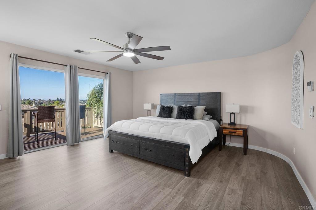 1777 Clover Tree Court Chula Vista, CA 91913 - Photo 22 of 49 a bedroom with a large bed and a chandelier