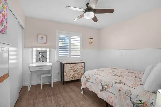 a bedroom with a bed and a desk