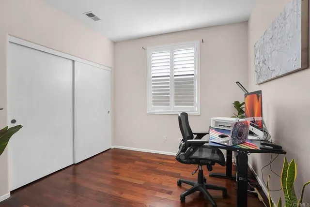 a view of a workspace with furniture and a window