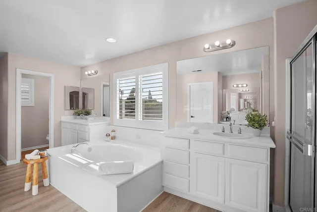 a bathroom with a tub sink and mirror